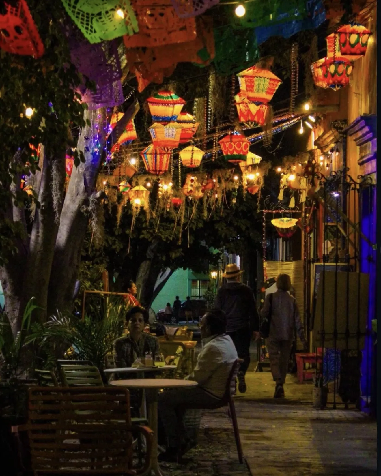 A street in Jalatlaco at night, with papel picado and lanterns